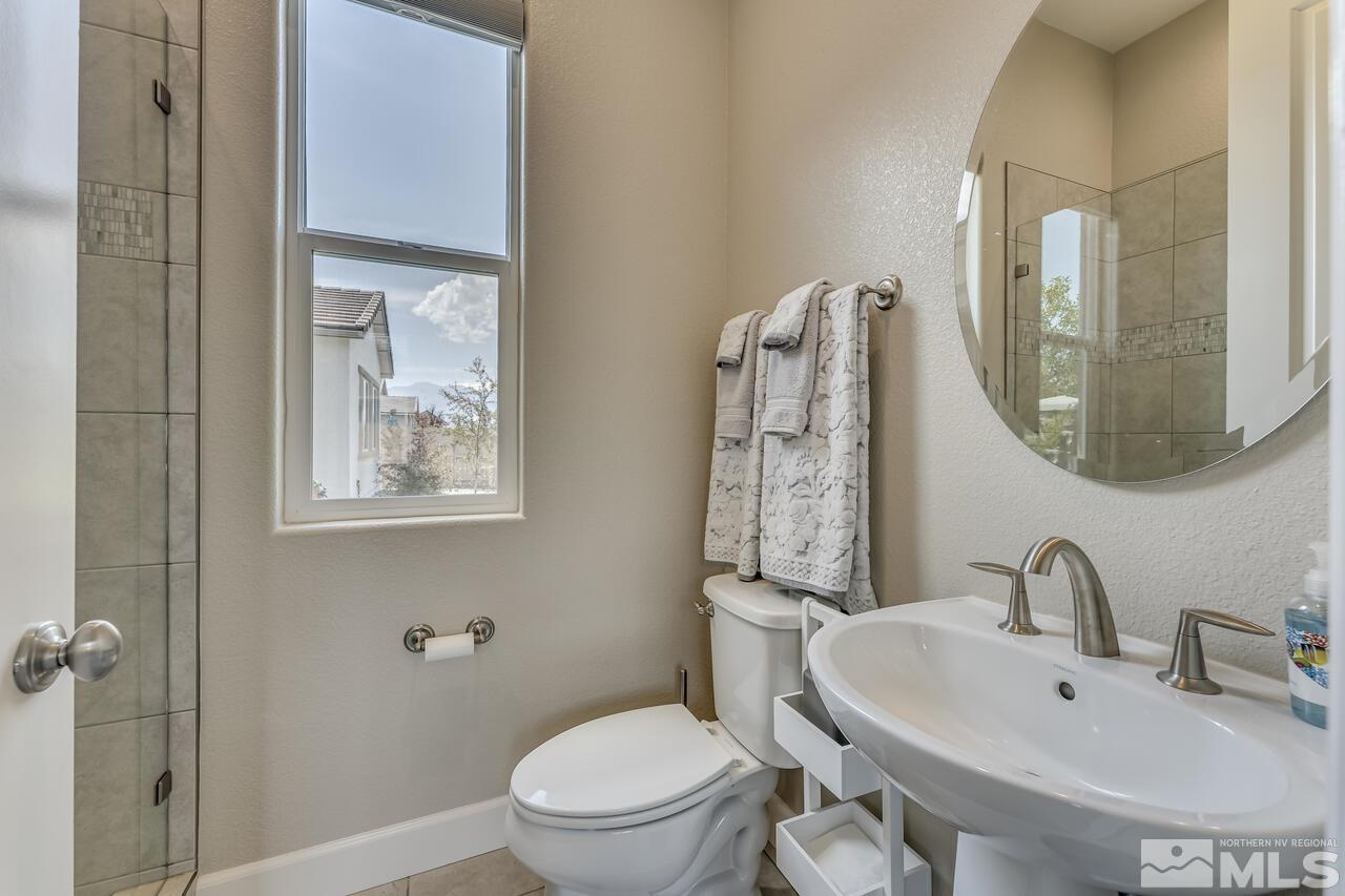 1933 Phaethon Lane Reno, NV 89521 - Photo 25 of 38 a bathroom with a toilet a sink and mirror