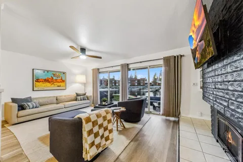 a living room with furniture a fireplace and a flat screen tv