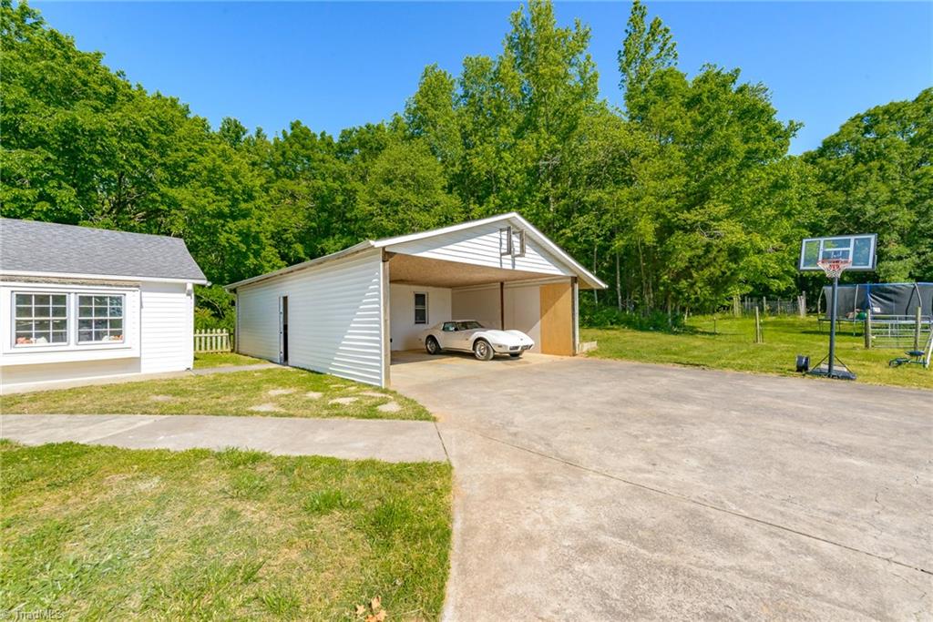 4780 Cooper Road Clemmons, NC 27012 - Photo 21 of 25 Detached carport has a workshop/office with electricity. Also has pull down attic steps for more storage.