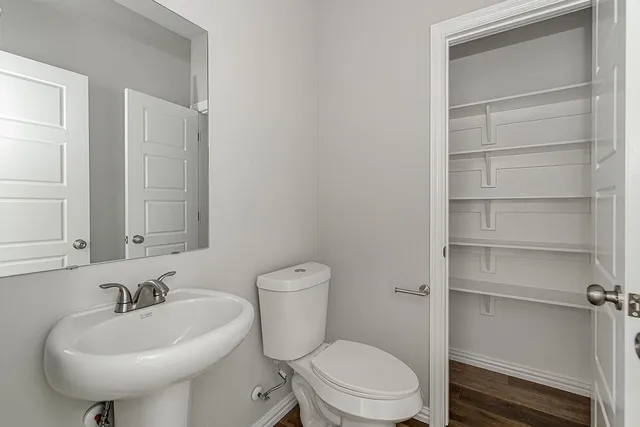 a bathroom with a sink toilet and a mirror