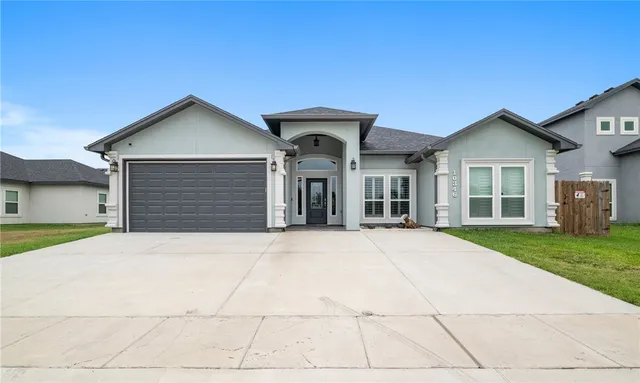 a front view of a house with a yard and garage