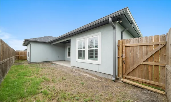 a backyard of a house with a garage