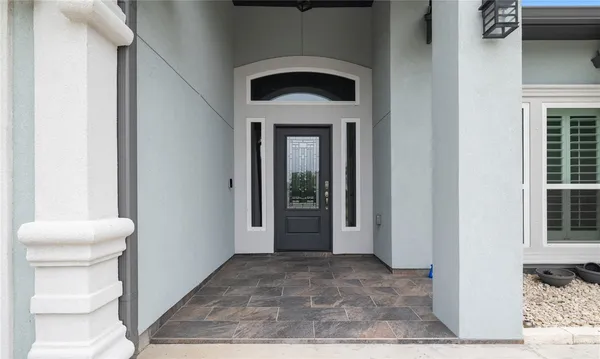 a view of a hallway with toilet and a window