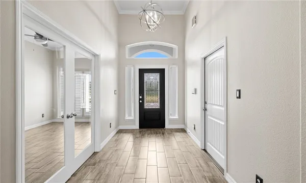 a view of a hallway with wooden floor and closet