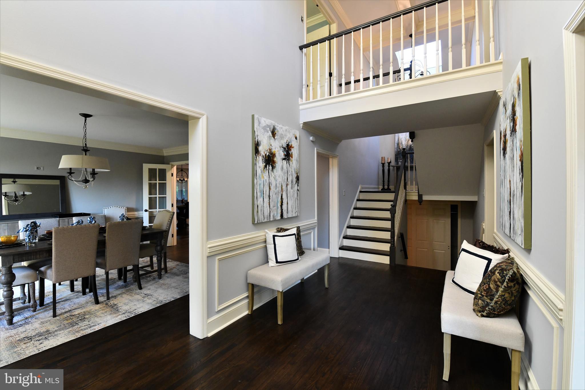 425 Inveraray Villanova, PA 19085 - Photo 5 of 53 a hallway with couches and dining table with wooden floor