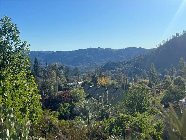 a view of a lush green hillside and a building