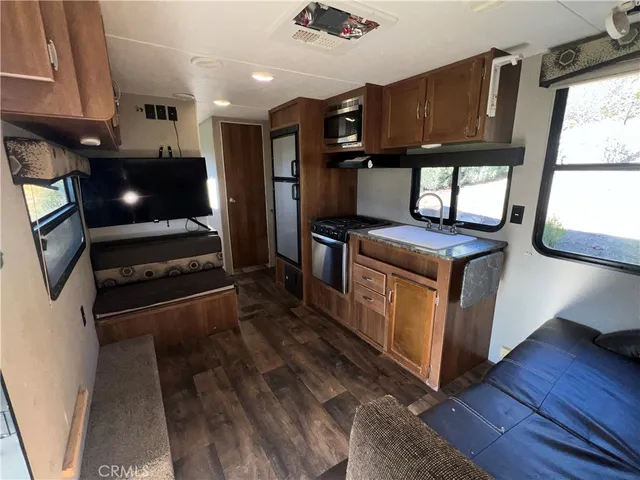 a kitchen with wooden cabinets and a stove top oven