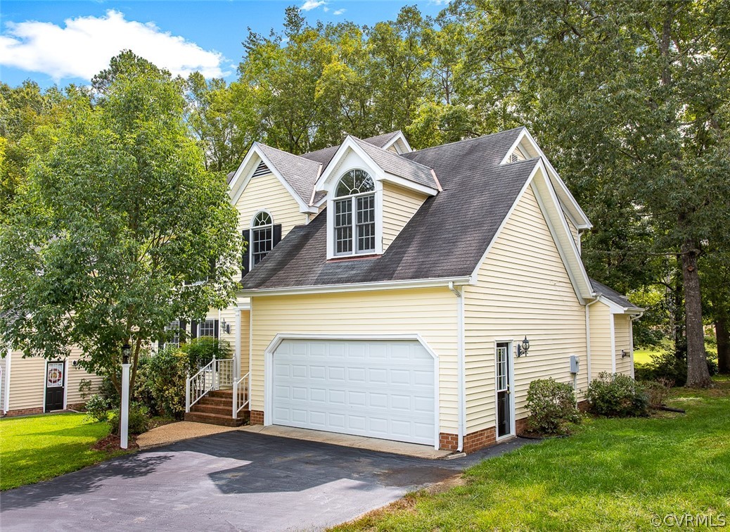 13902 Sagebrook Road Midlothian, VA 23112 - Photo 2 of 37 a front view of a house with a yard and garage