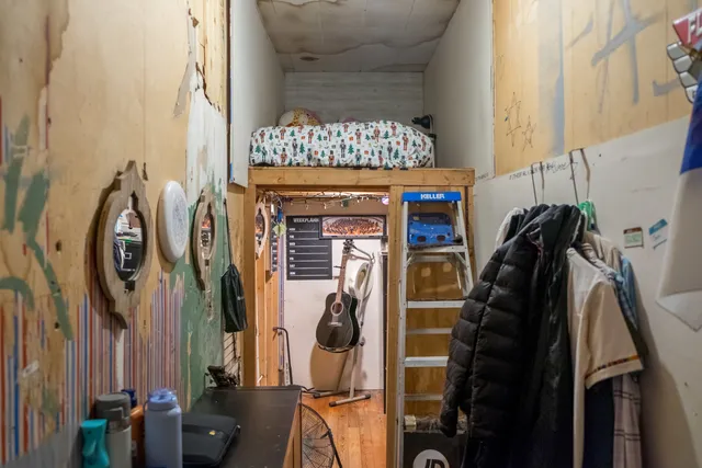 a view of walk in closet with clothes