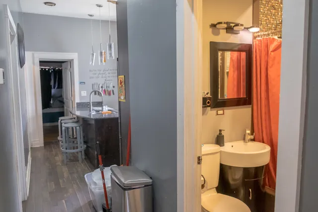 a bathroom with a sink a toilet and shower