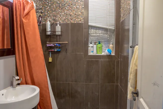 a white toilet sitting next to a bathroom sink