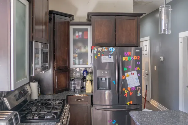 a kitchen with a refrigerator and a sink