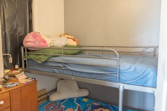 a bedroom with a bed and a dresser