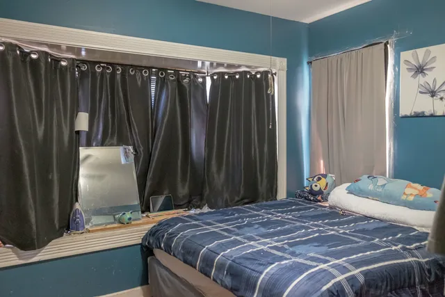 a bedroom with a large bed and a window