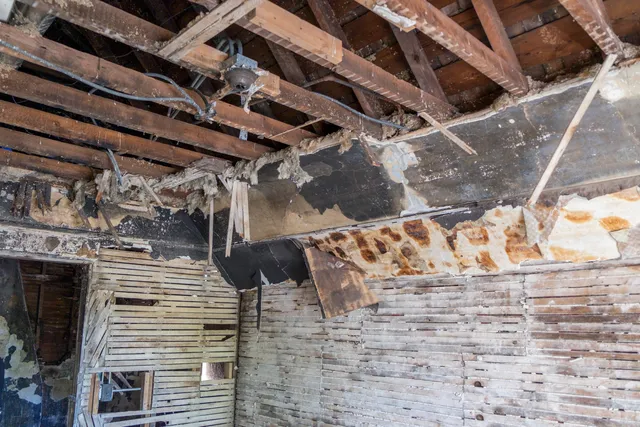 a bathroom with a granite countertop sink a mirror and shower