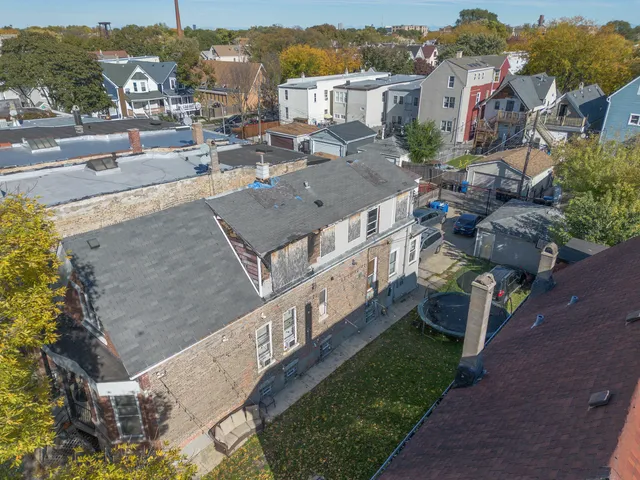 an aerial view of a house with a yard basket ball court and outdoor seating