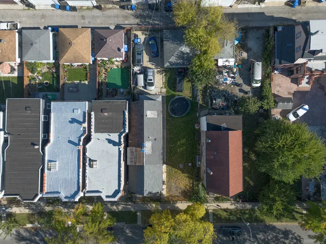 an aerial view of houses with yard