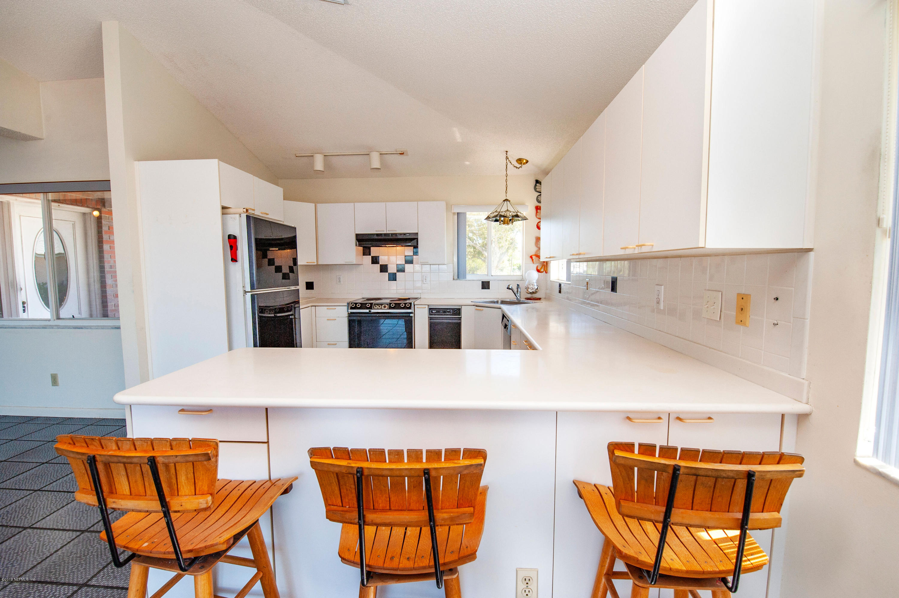 6333 Salado Road St. Augustine, FL 32080 - Photo 13 of 33 a kitchen with stainless steel appliances kitchen island a table and chairs