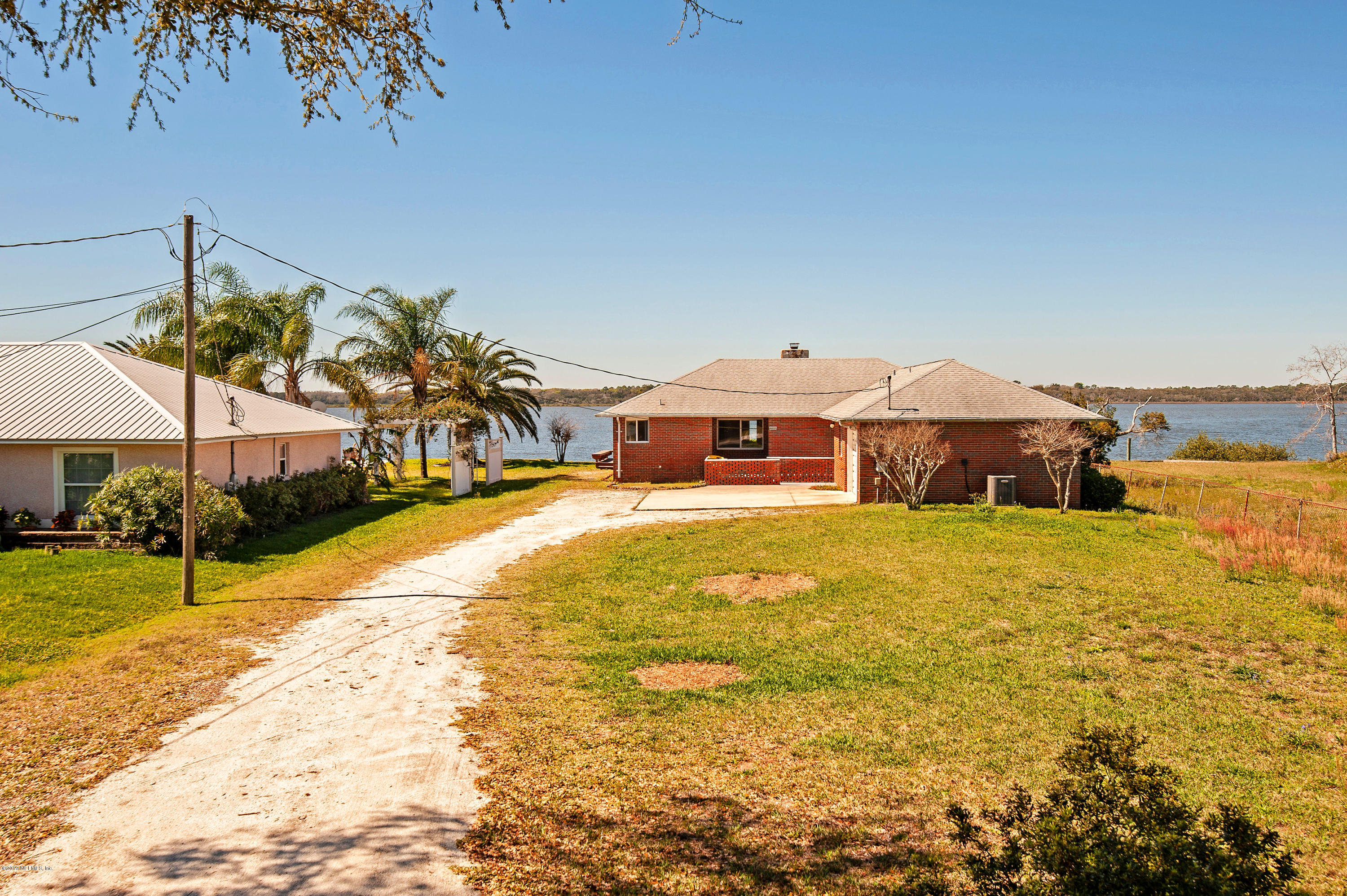 6333 Salado Road St. Augustine, FL 32080 - Photo 5 of 33 a front view of a house with a yard swimming pool and outdoor space