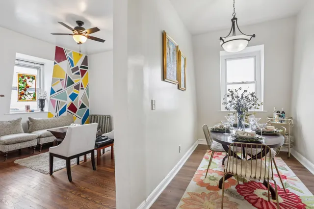 a view of a dining room with furniture wooden floor and a chandelier