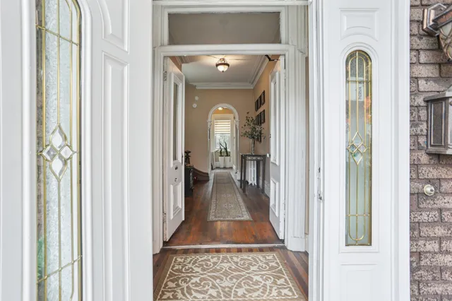 a view of a hallway with a livingroom and a livingroom with furniture