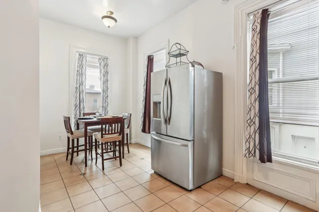 a kitchen with stainless steel appliances granite countertop a refrigerator and a stove top oven