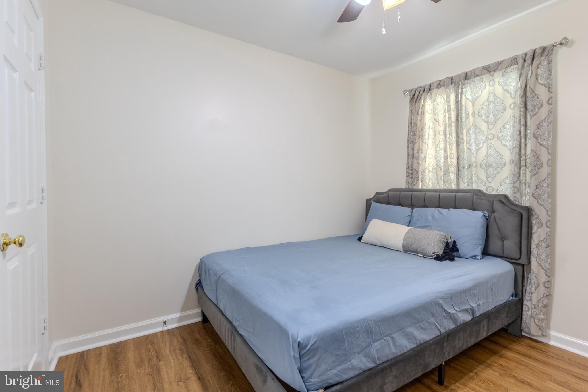 7530 Haystack Drive Windsor Mill, MD 21244 - Photo 16 of 30 a bedroom with a bed and a window