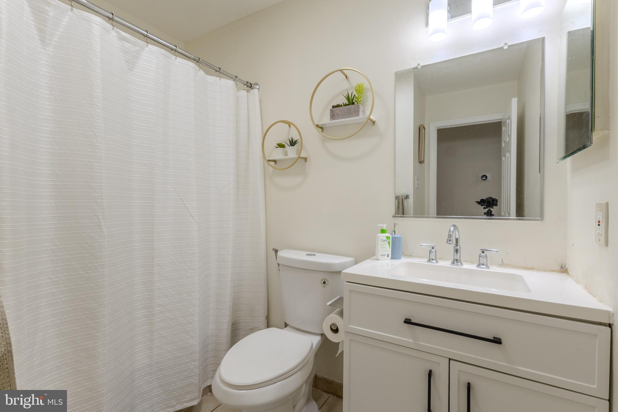7530 Haystack Drive Windsor Mill, MD 21244 - Photo 18 of 30 a bathroom with a sink a toilet and a mirror