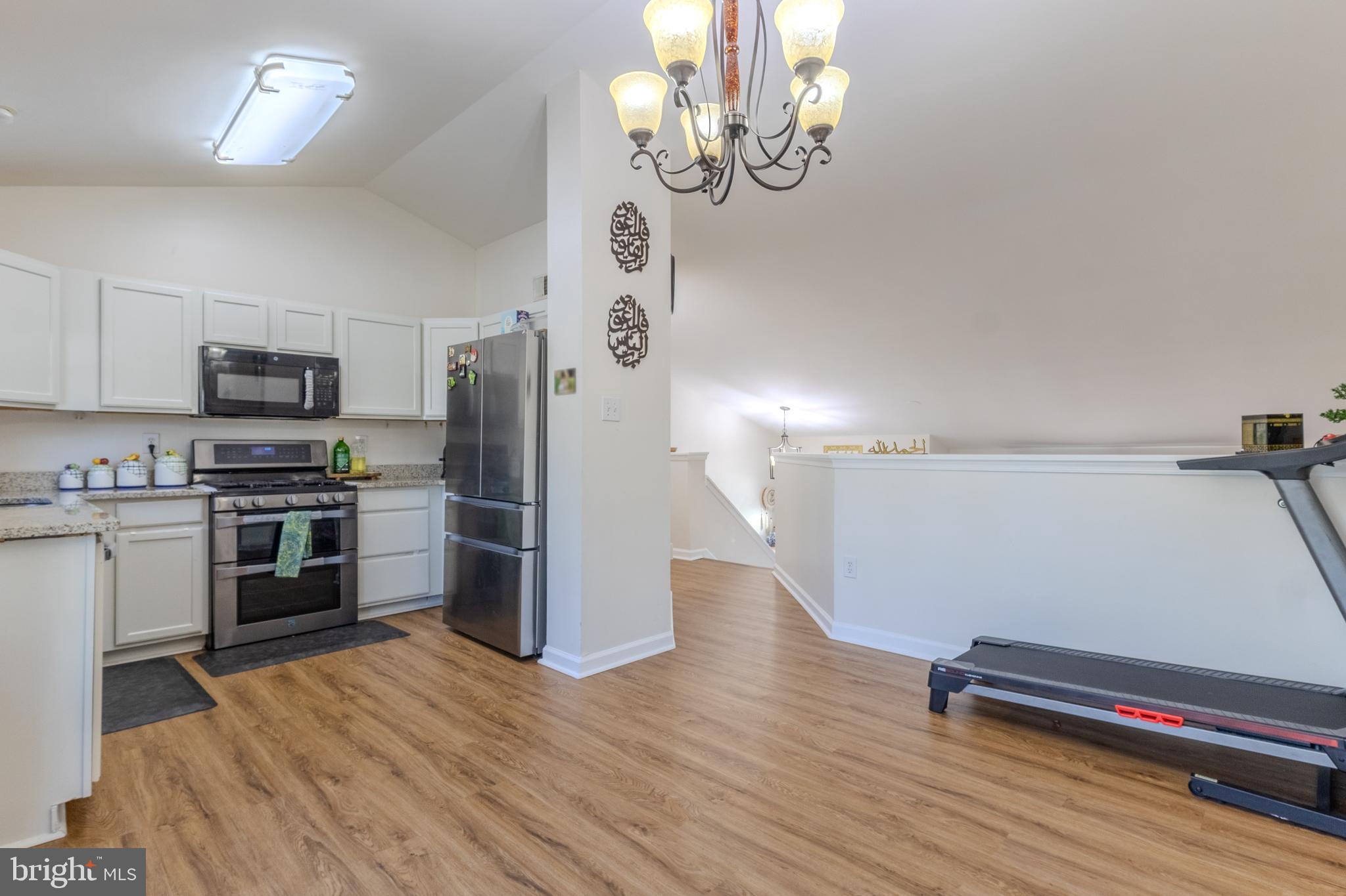 7530 Haystack Drive Windsor Mill, MD 21244 - Photo 9 of 30 a kitchen with a refrigerator and a stove top oven