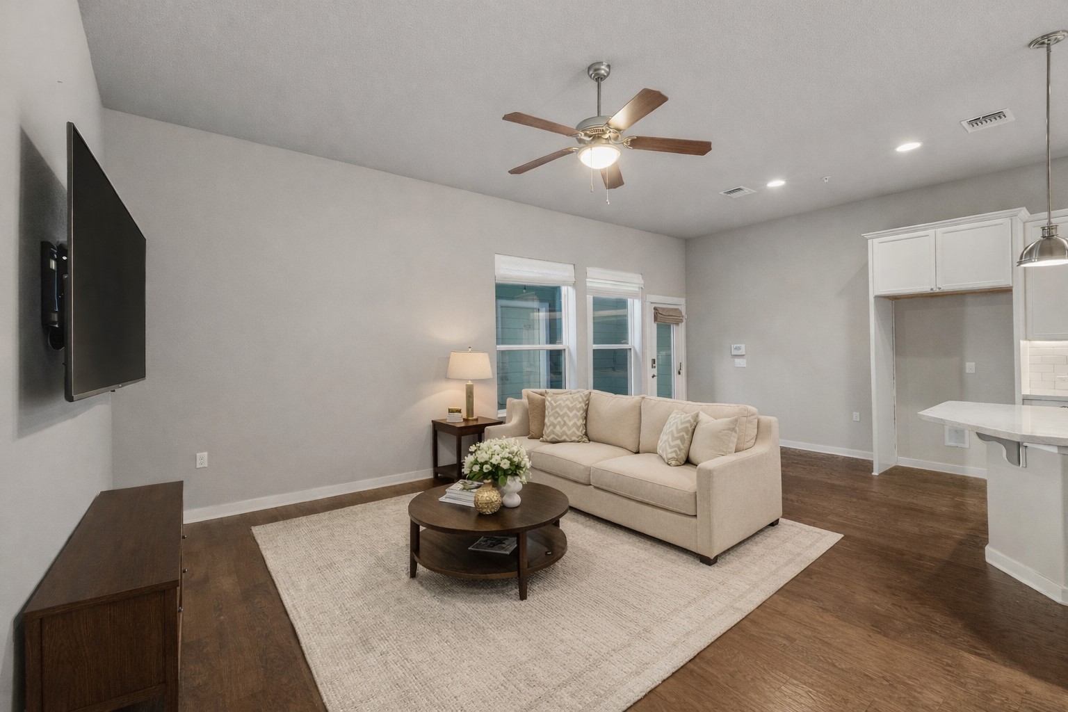3919 Vaughan Street Austin, TX 78723 - Photo 19 of 40 An inviting open-concept living area flows seamlessly into the kitchen, anchored by rich hardwood flooring.