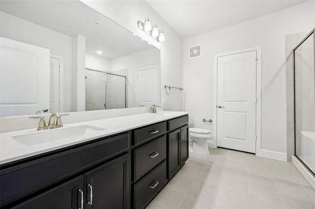 a bathroom with a double vanity sink mirror and double