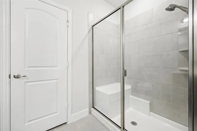 a bathroom with a glass shower door