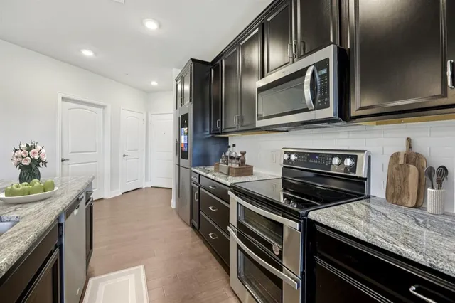 a kitchen with stainless steel appliances and stove top oven