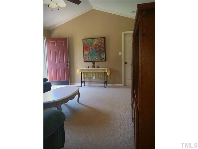 1487 Lee Road Clayton, NC 27520 - Photo 8 of 22 a living room with furniture and a table