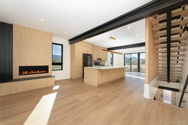 a large white kitchen with a large window