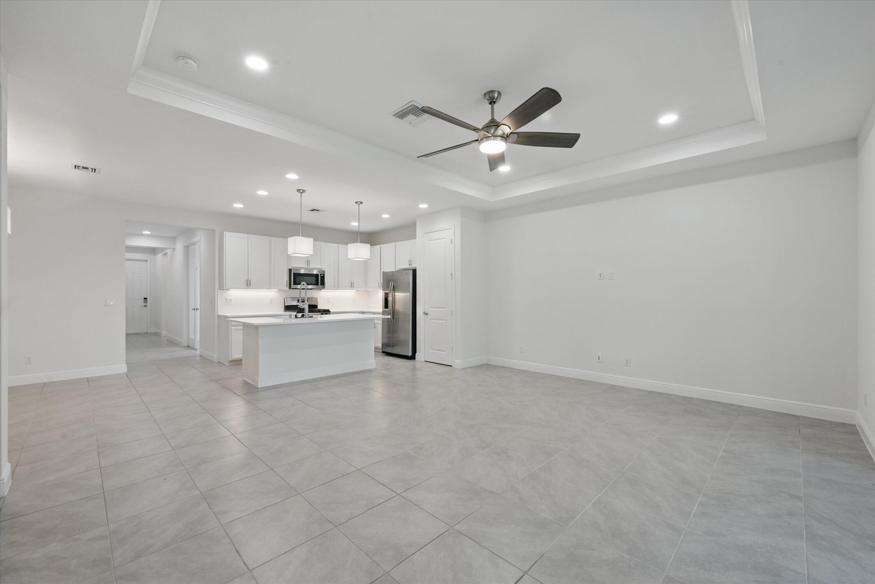 879 Ember Ridge Run Loxahatchee, FL 33470 - Photo 12 of 38 16-Living Room to Kitchen