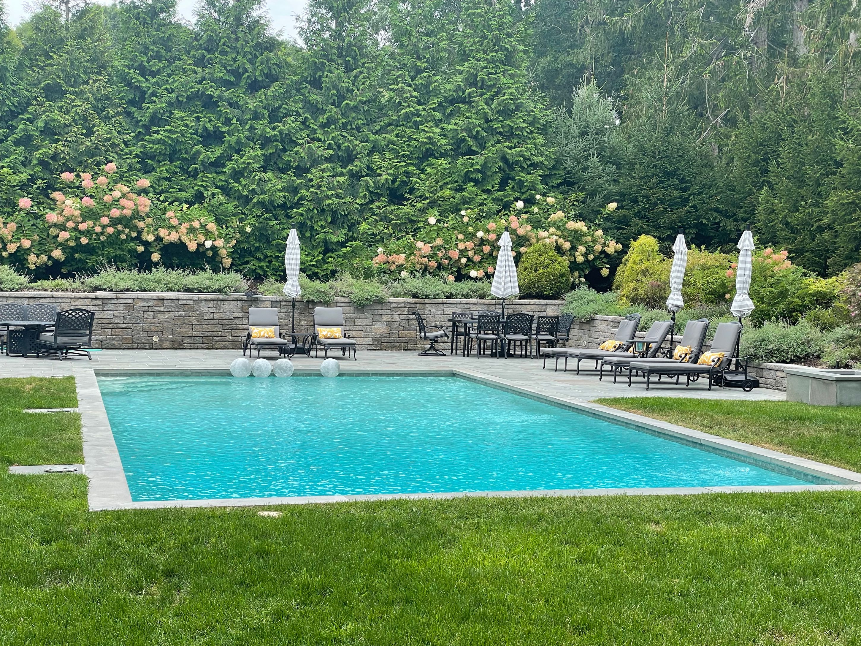 20 Lighthouse Lane Sag Harbor, NY 11963 - Photo 1 of 31 a view of a swimming pool with a garden