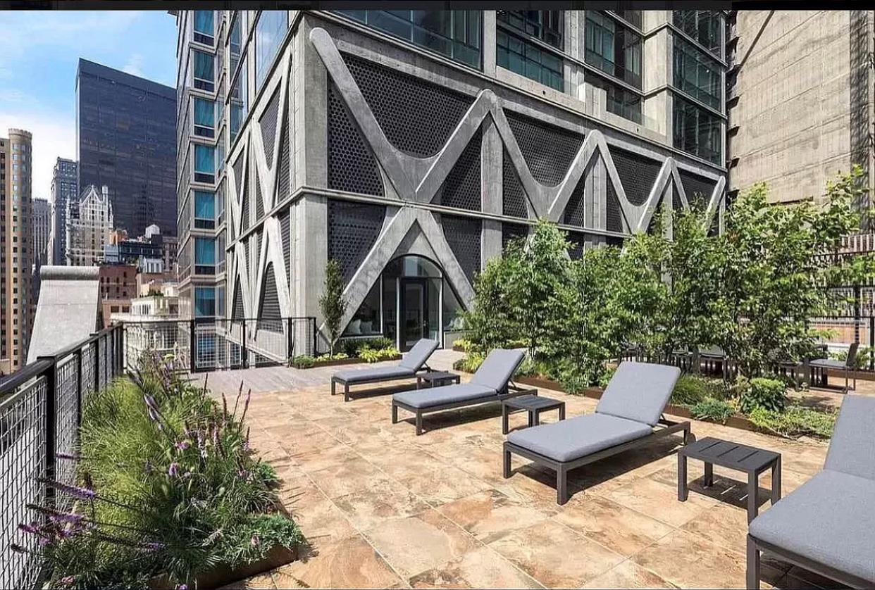 5 Beekman Street, Unit 18C Manhattan, NY 10038 - Photo 15 of 21 a backyard of a house with outdoor seating