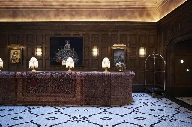 a view of a dining room with furniture a chandelier and large windows