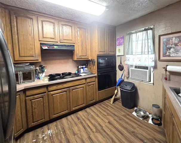 a kitchen with stainless steel appliances a sink stove and refrigerator
