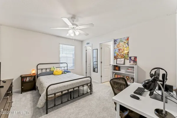 a bedroom with a bed and a table in it