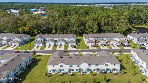 an aerial view of residential houses with outdoor space