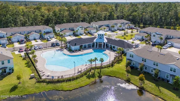 an aerial view of a house with swimming pool garden and patio