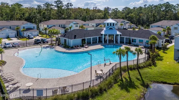 an aerial view of a house with garden space and lake view