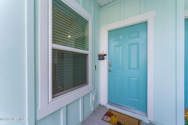 a view of a bathroom that has a window and door