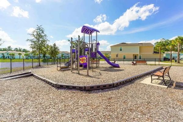 a view of a park with swings and slides