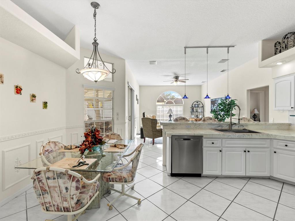 8704 Cypress Lakes Boulevard New Port Richey, FL 34653 - Photo 16 of 43 a kitchen with stainless steel appliances kitchen island granite countertop a sink and cabinets