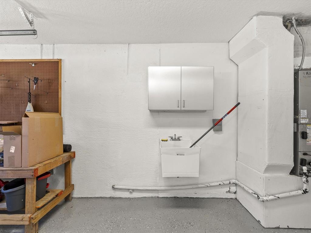 8704 Cypress Lakes Boulevard New Port Richey, FL 34653 - Photo 38 of 43 a view of a room with rack and cabinets