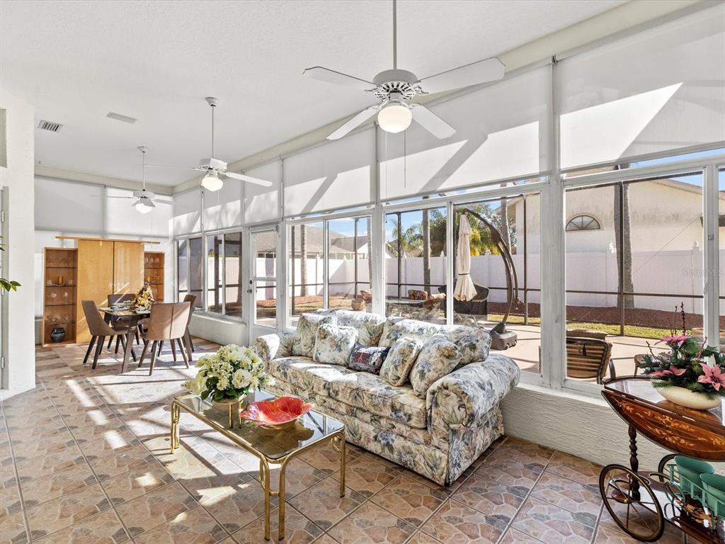 8704 Cypress Lakes Boulevard New Port Richey, FL 34653 - Photo 5 of 43 a living room with furniture and a large window