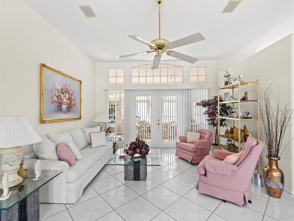 8704 Cypress Lakes Boulevard New Port Richey, FL 34653 - Photo 10 of 43 a living room with furniture a chandelier and a chandelier
